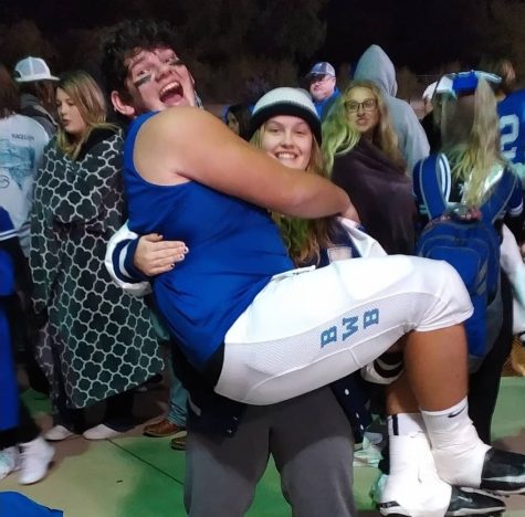 A tradition after every football game, Abby uses her strength to pick Bear up.